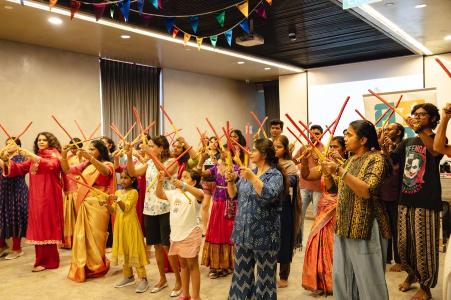 Participants raising the sticks in unison during the workshop