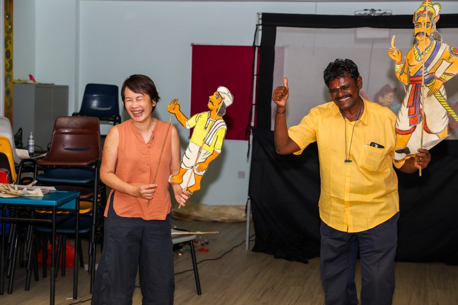 Two participants performing with shadow puppets