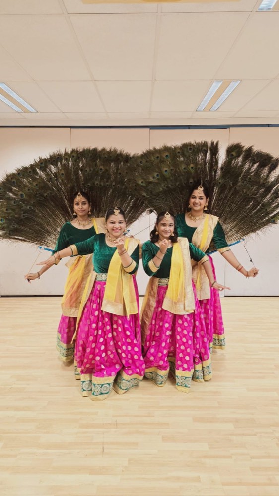 A Mayilattam performer in peacock costume